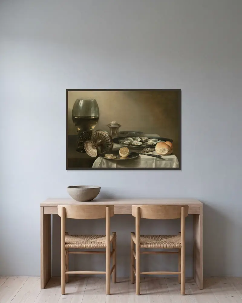 A large roemer, overturned tazza, salt cellar, partially sliced lemon, oysters, pepper, knife and bread on a partially draped table av Pieter Claesz inramad på en vägg