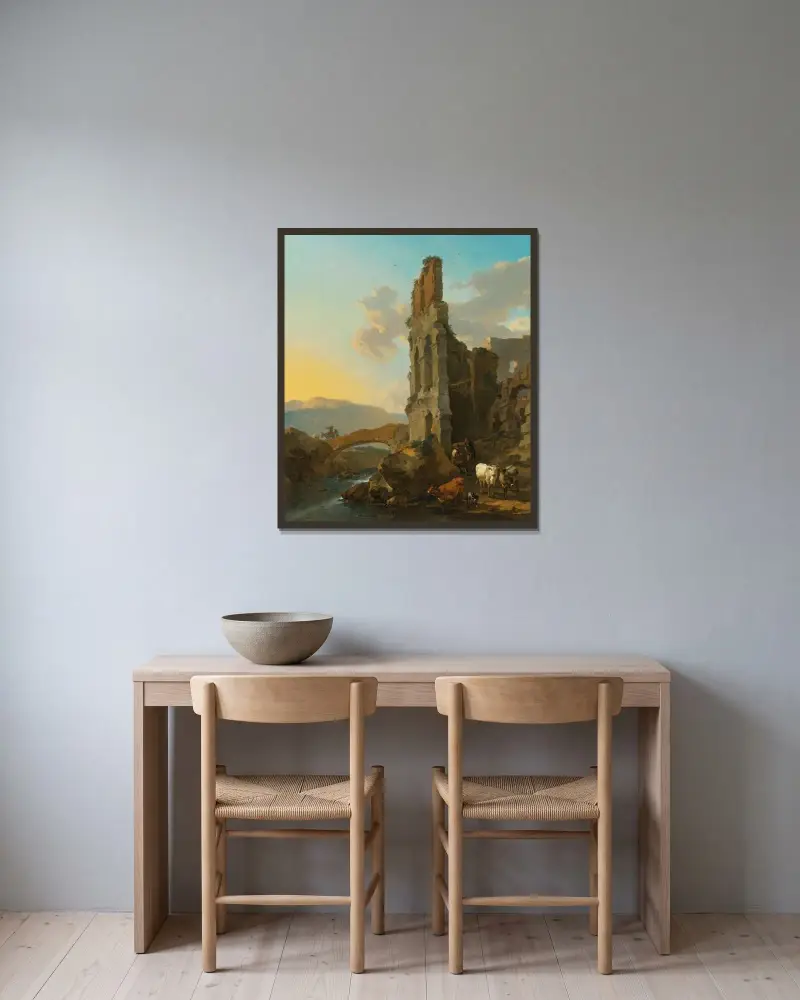 Italienskt flodlandskap med herdar vid ruinerna av en amfiteater och bönder som korsar en bro av Nicolaes Pietersz. Berchem inramad på en vägg