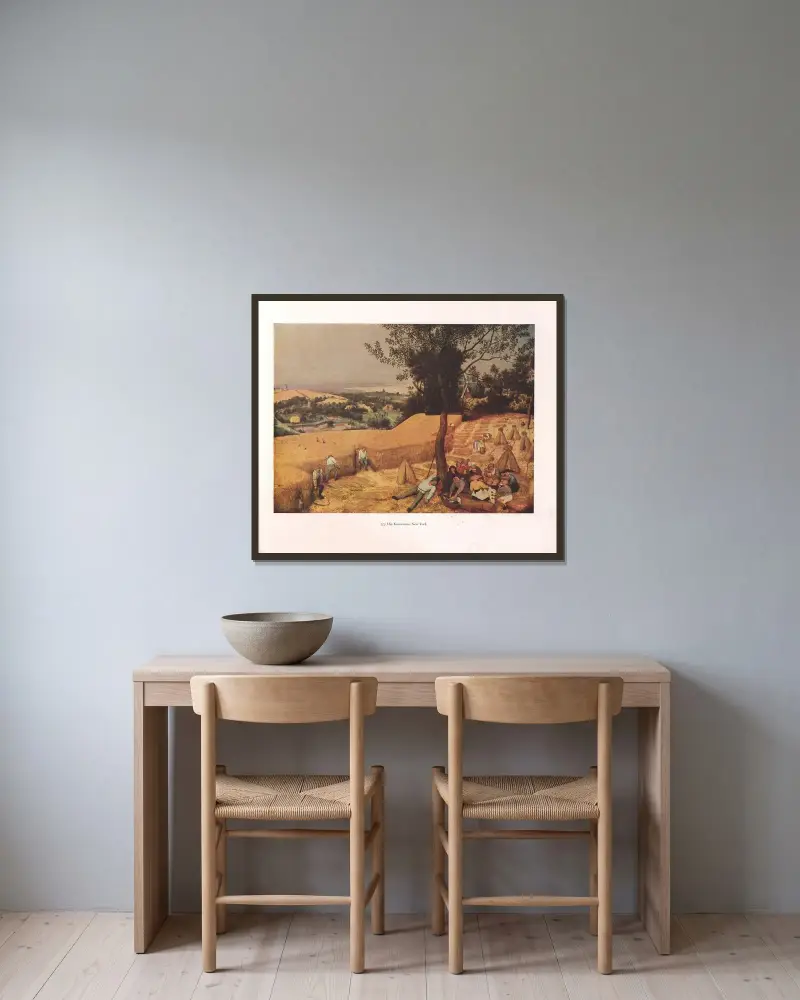 Die Kornernte von Pieter Bruegel The Elder gerahmt an einer Wand