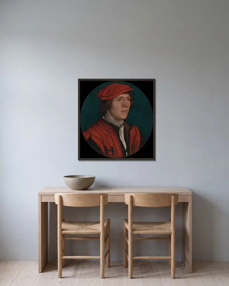 Porträt eines Mannes mit roter Mütze von Hans Holbein The Younger gerahmt an einer Wand