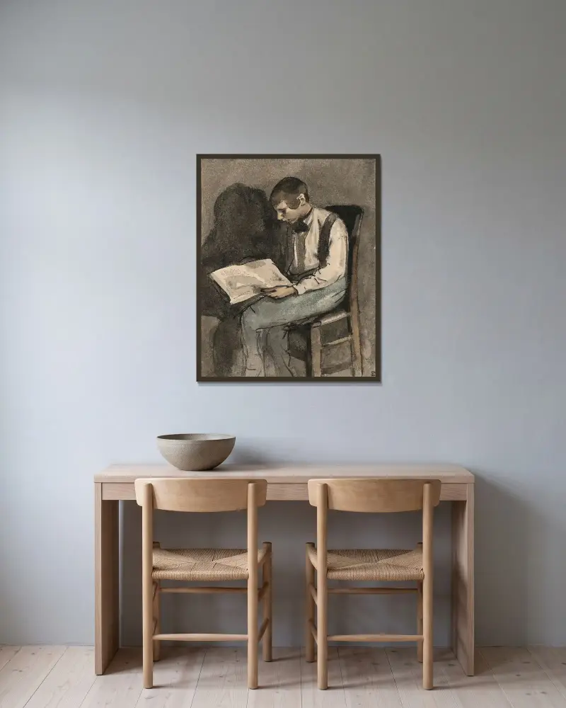 Ung man sittande läsande av Théodule Ribot inramad på en vägg