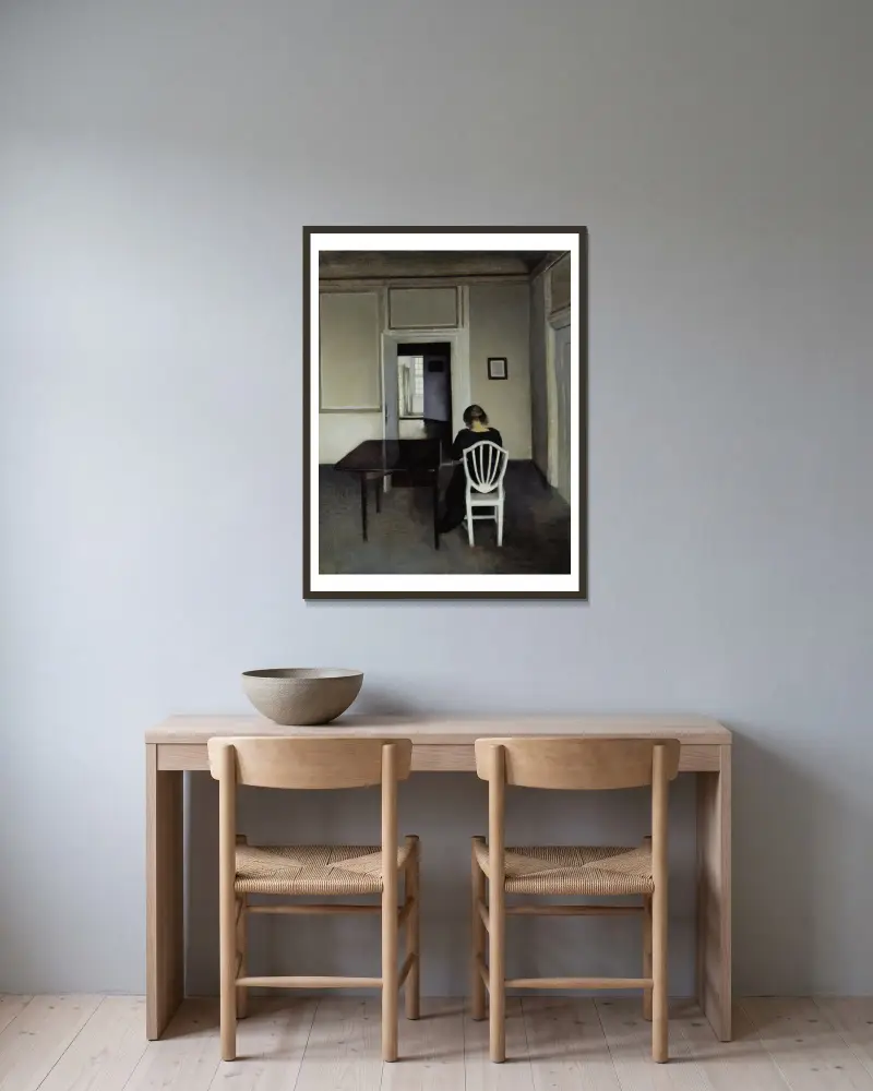Interior With Ida in A White Chair av Vilhelm Hammershøi inramad på en vägg