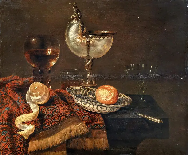 A clementine in a porcelain bowl, a nautilus cup, a roemer, two glasses, a knife, a peeled lemon on an ornamental carpet on a table av Willem Claesz Heda