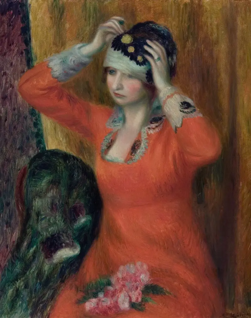 Flicka i röd klänning som fäster en hatt av William James Glackens