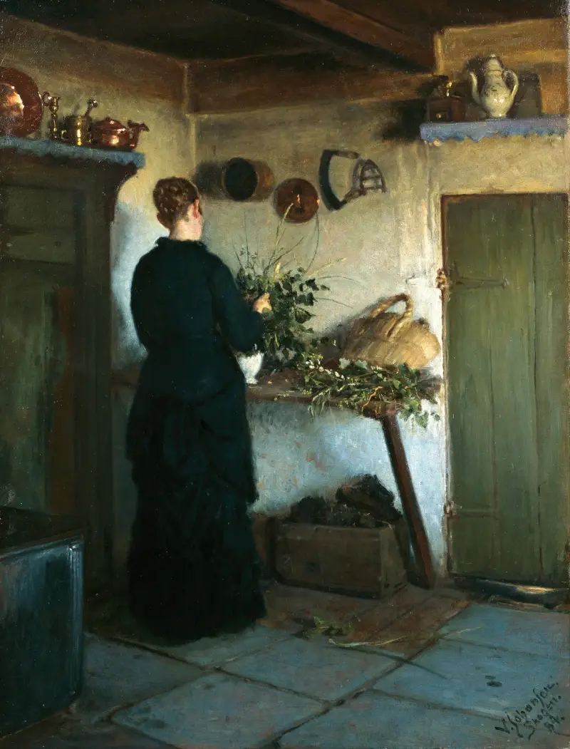 Kitchen interior. The artist’s wife arranging flowers av Viggo Johansen